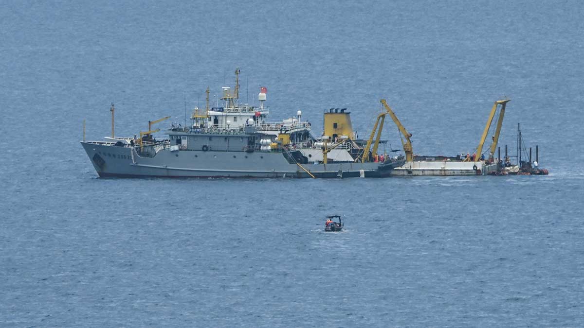Ships identified by the Philippine Coast Guard as Chinese research vessels are seen at Scarborough Shoal in the disputed South China Sea on June 15, 2026. (Photo by Jam STA ROSA / AFP)
